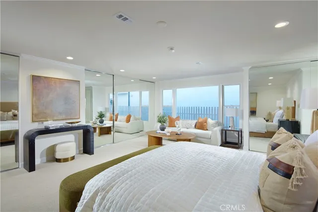 a large bedroom with bed and large windows