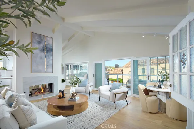 a living room with fireplace furniture and a large window