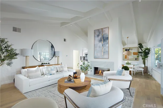 a living room with furniture a rug and a mirror