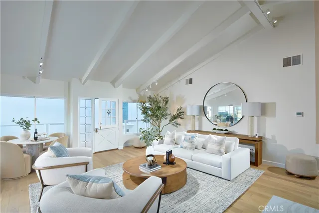a living room with furniture a chandelier and a dining room