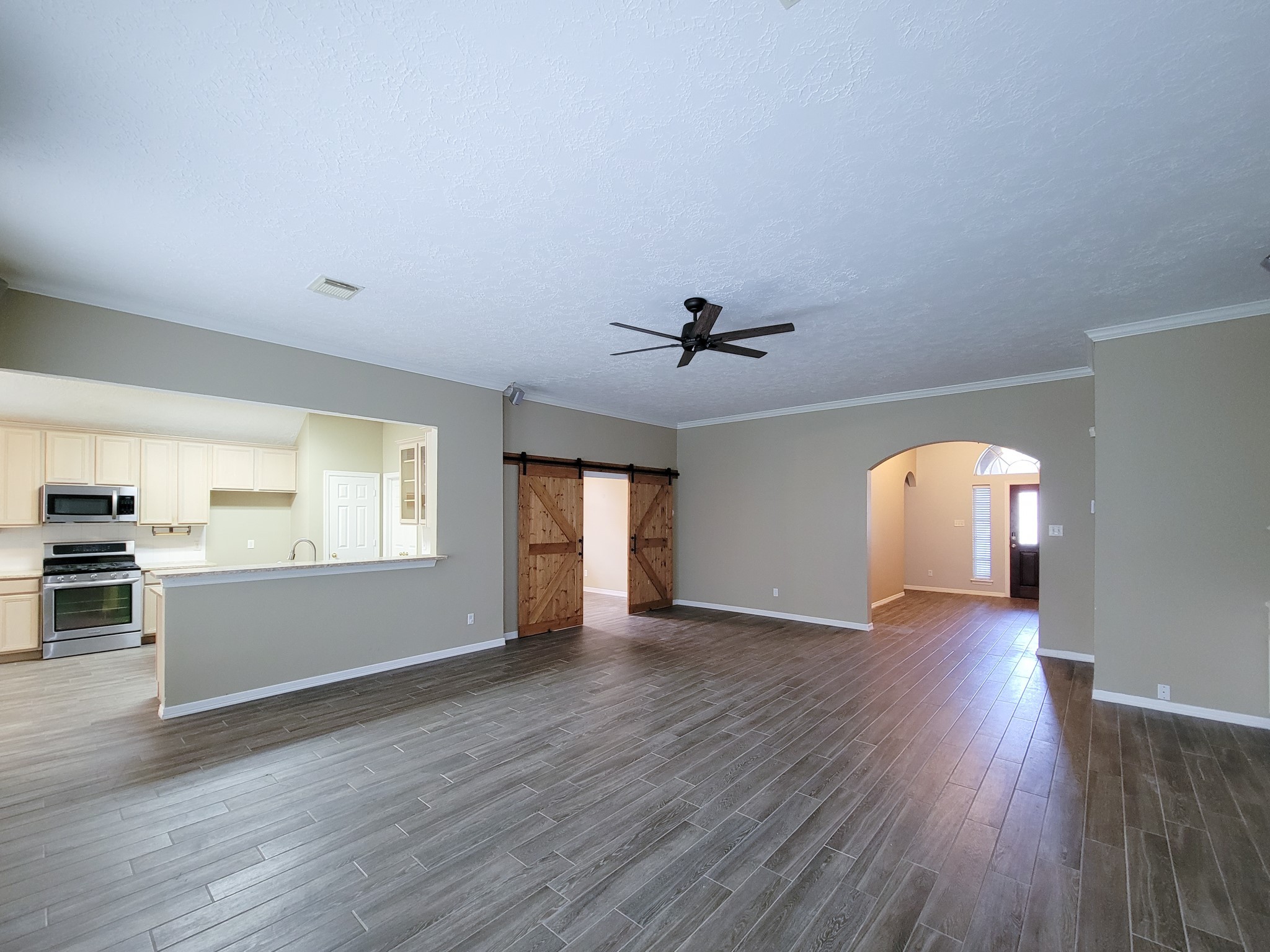 18511 Falcon Crest Drive Humble, TX 77346 - Photo 11 of 35 a view of an empty room with a window and wooden floor
