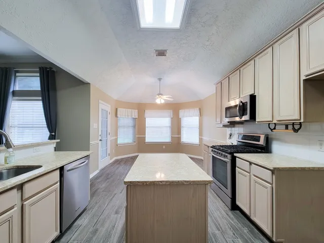 a kitchen with a sink stove and refrigerator