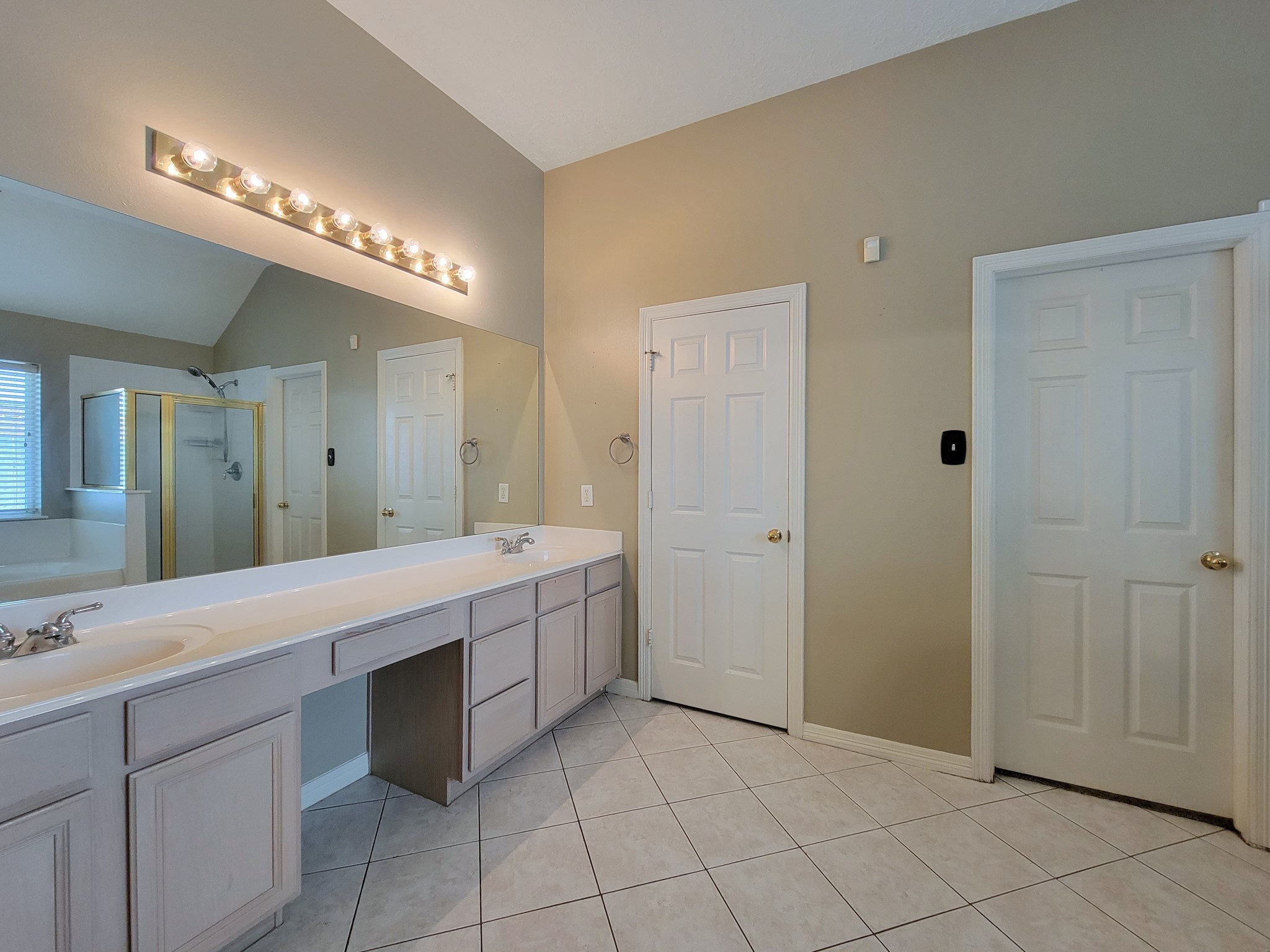 18511 Falcon Crest Drive Humble, TX 77346 - Photo 21 of 35 a spacious bathroom with a double vanity sink a mirror and a bathtub