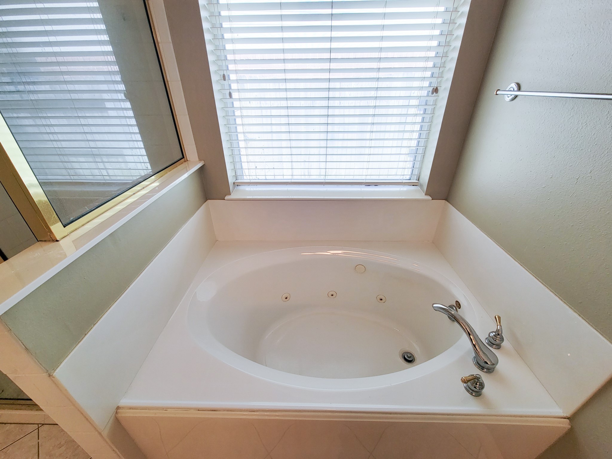 18511 Falcon Crest Drive Humble, TX 77346 - Photo 23 of 35 a white bath tub sitting in a bathroom next to a window