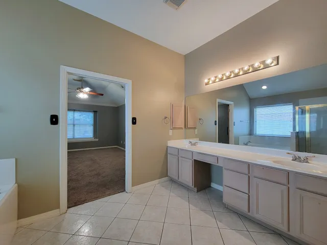 an empty room with a window and a fan