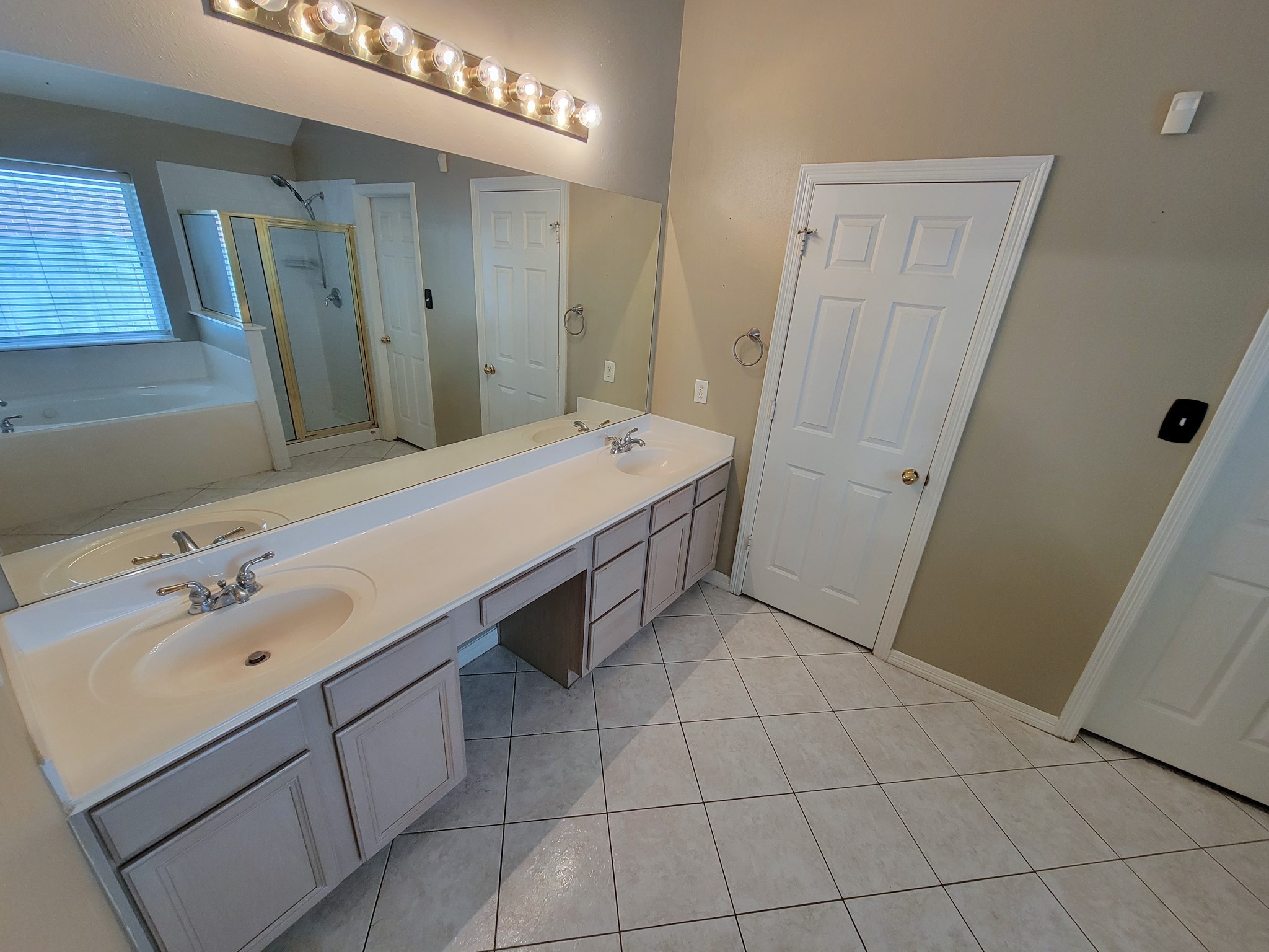 18511 Falcon Crest Drive Humble, TX 77346 - Photo 26 of 35 a spacious bathroom with a sink vanity and mirror