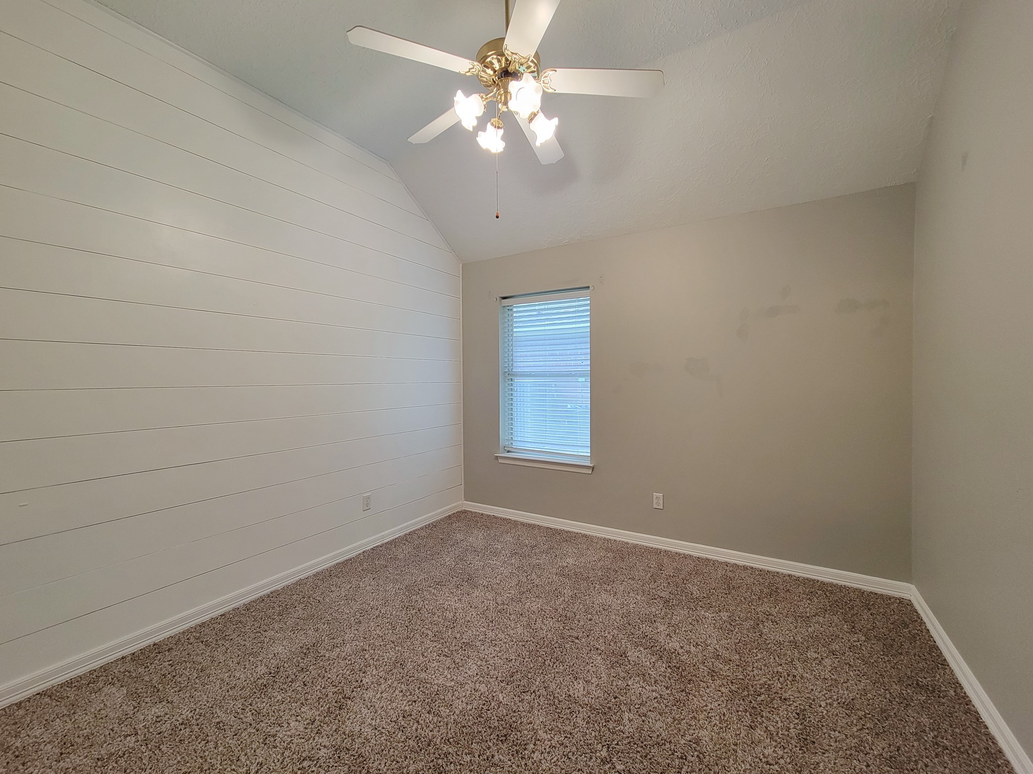 18511 Falcon Crest Drive Humble, TX 77346 - Photo 27 of 35 an empty room with a window and a fan