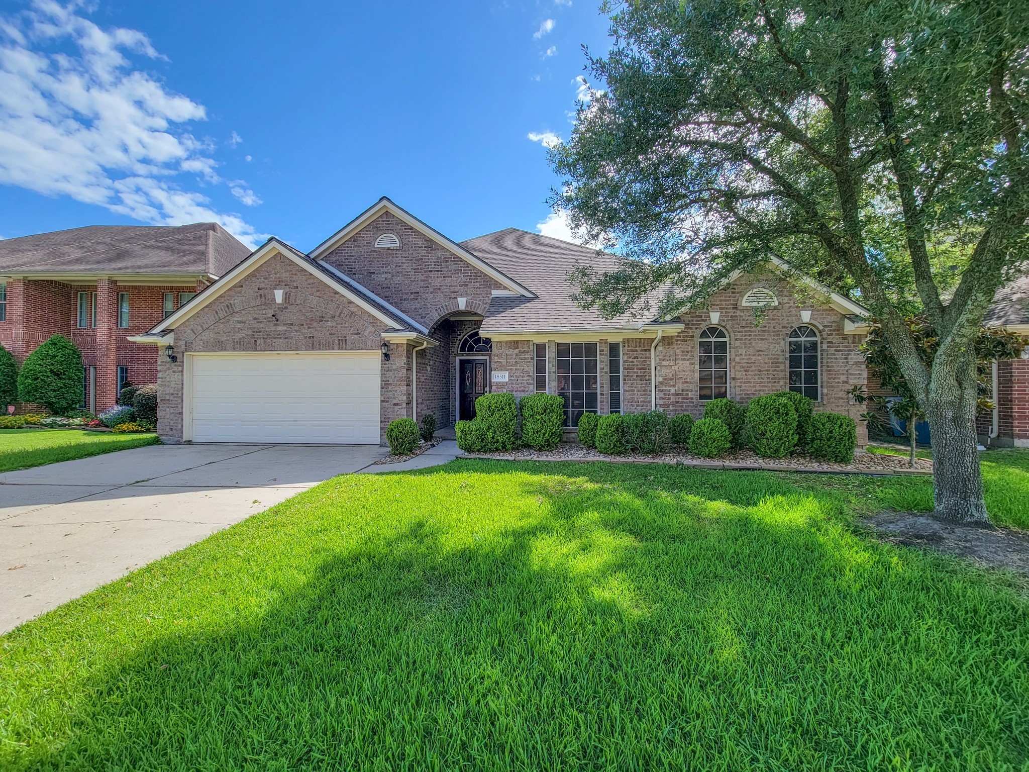 18511 Falcon Crest Drive Humble, TX 77346 - Photo 3 of 35 a front view of a house with a garden and yard