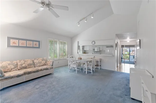 a living room with furniture and a dining table