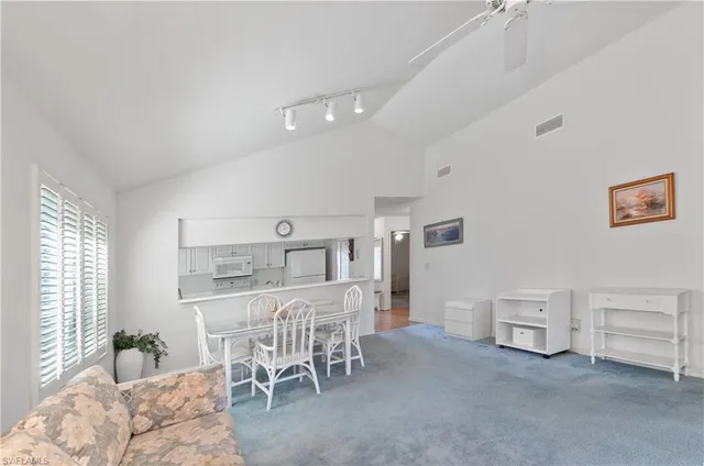 a living room with furniture and a dining table
