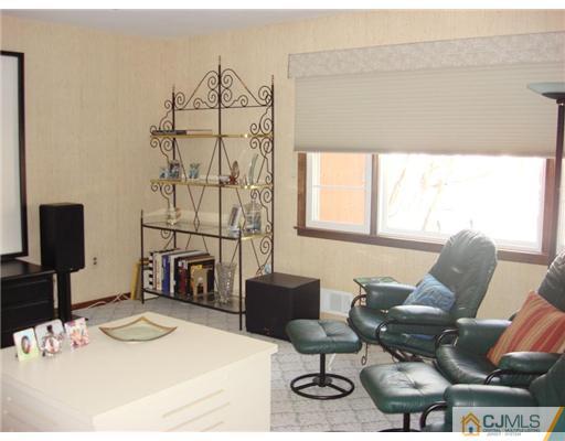 16 Fishel Road Edison, NJ 08820 - Photo 12 of 25 a living room with furniture a flat screen tv and a table