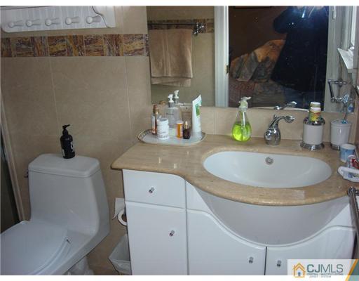 16 Fishel Road Edison, NJ 08820 - Photo 16 of 25 a bathroom with a toilet and a sink