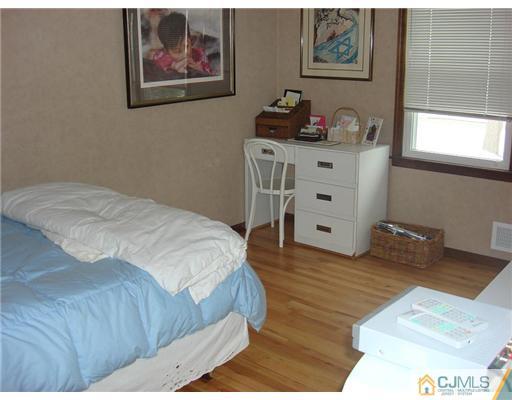 16 Fishel Road Edison, NJ 08820 - Photo 18 of 25 a bedroom with a bed and a cabinet