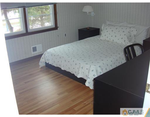 16 Fishel Road Edison, NJ 08820 - Photo 19 of 25 a bedroom with a bed and wooden floor
