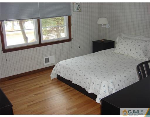 16 Fishel Road Edison, NJ 08820 - Photo 20 of 25 a bedroom with a bed and a window
