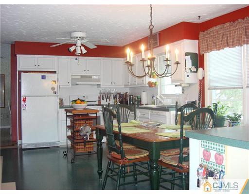 16 Fishel Road Edison, NJ 08820 - Photo 3 of 25 a kitchen with stainless steel appliances kitchen island granite countertop a table and chairs in it