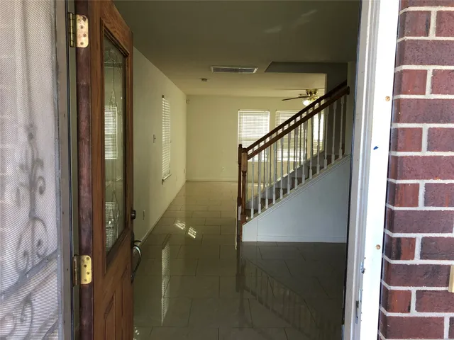 a view of staircase with white walls and a shower