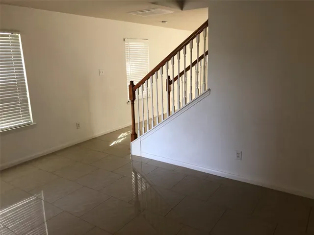 a view of a hallway with stairs