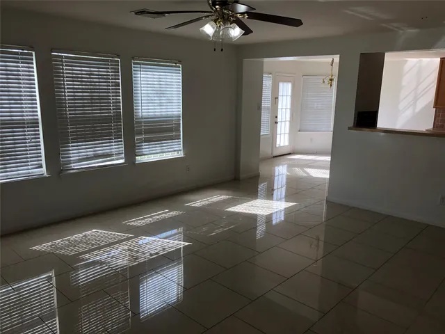 a kitchen with granite countertop a stove a sink and a refrigerator
