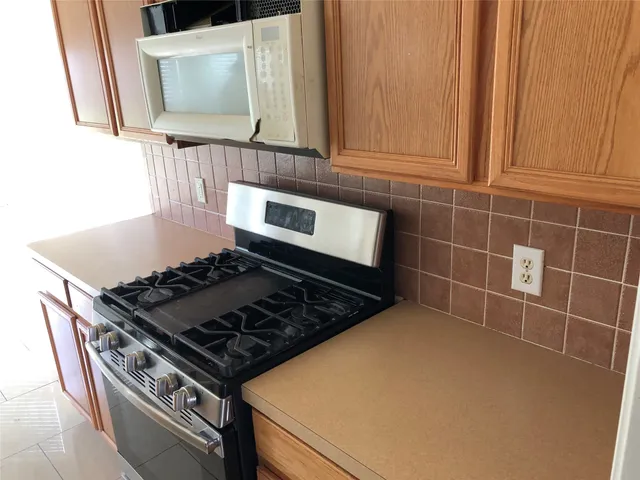 a kitchen with stainless steel appliances a refrigerator and sink