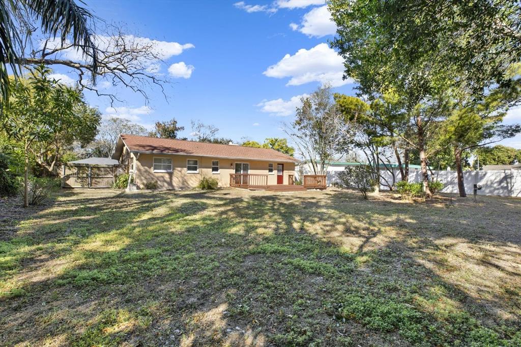 3485 Pine Street Dunedin, FL 34698 - Photo 12 of 22 a front view of a house with a yard