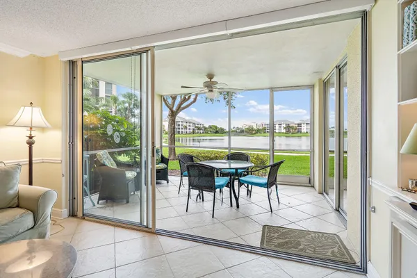 a dining room with furniture and a floor to ceiling window