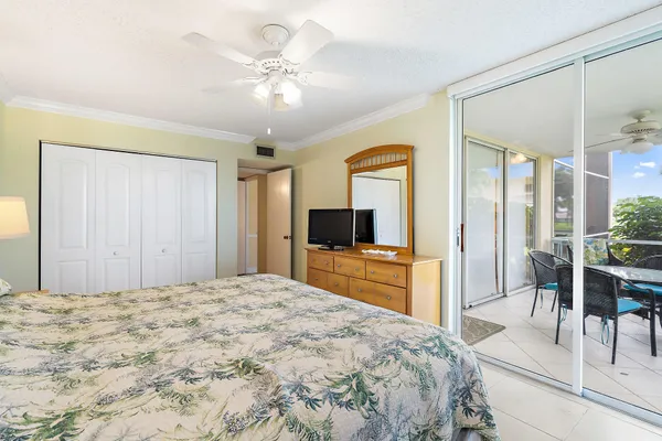 a bedroom with a large bed and a flat tv screen