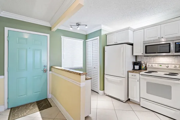 a kitchen with stainless steel appliances a refrigerator sink and microwave
