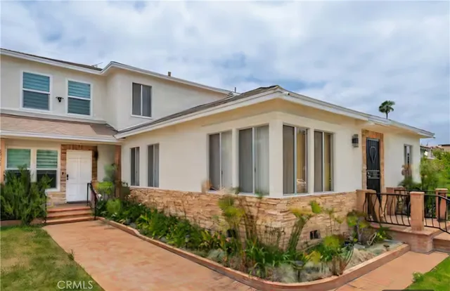 a front view of a house with garden