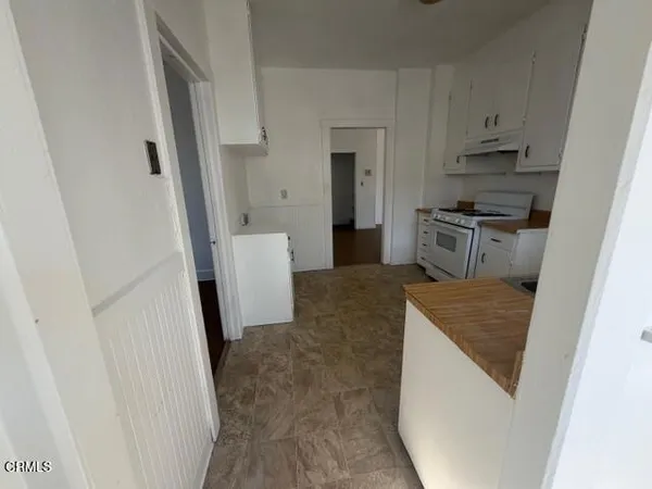 a kitchen with a refrigerator stove and a sink