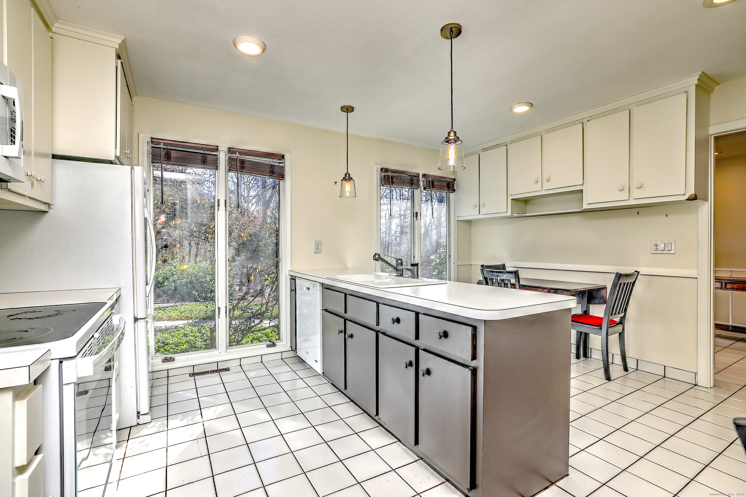 70 Woodfield Road Woodbridge, CT 06525 - Photo 14 of 37 a kitchen with a sink stove and cabinets