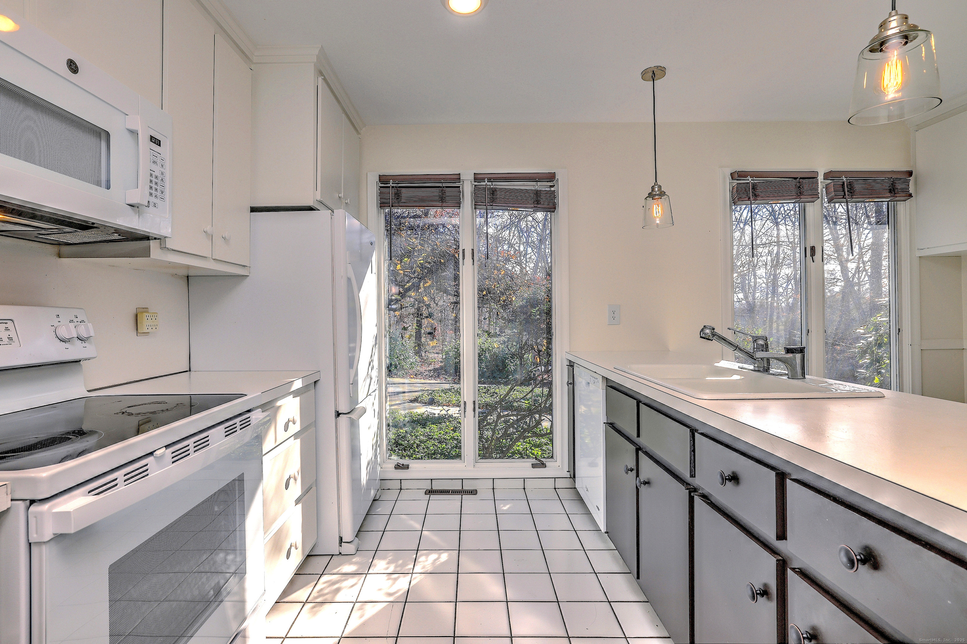 70 Woodfield Road Woodbridge, CT 06525 - Photo 15 of 37 a kitchen with stainless steel appliances a sink stove and cabinets