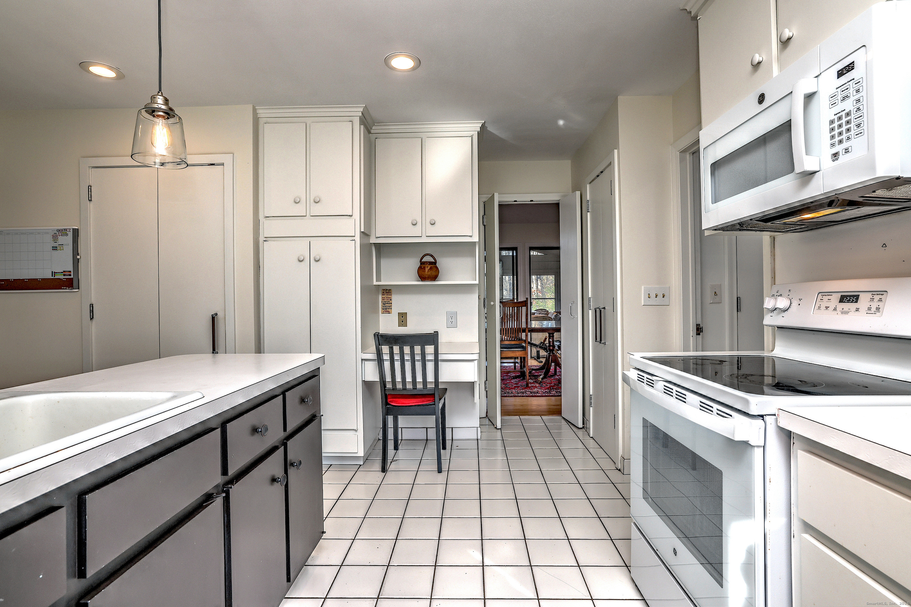 70 Woodfield Road Woodbridge, CT 06525 - Photo 16 of 37 a kitchen with stainless steel appliances kitchen island granite countertop a refrigerator a sink and a stove