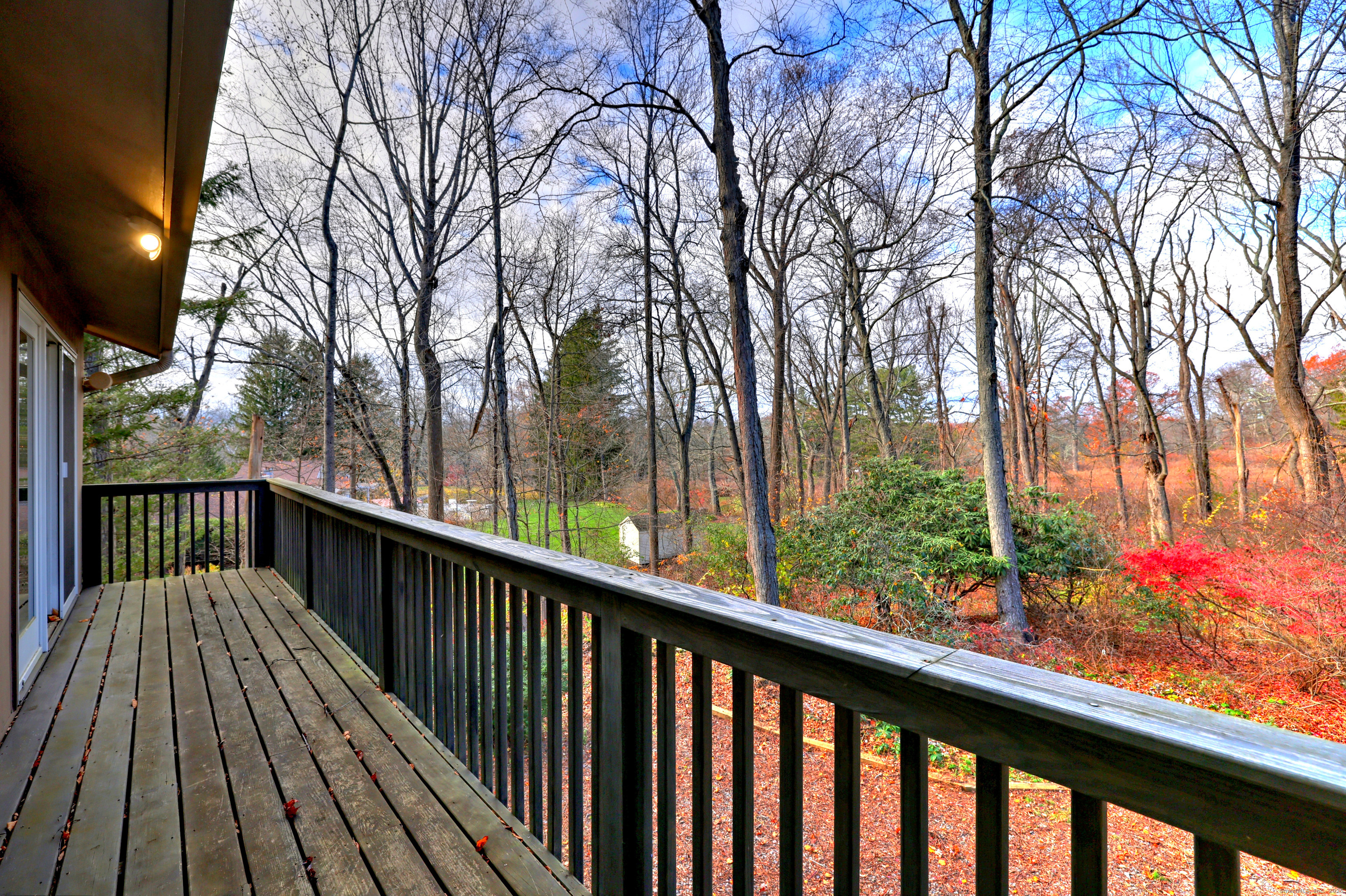 70 Woodfield Road Woodbridge, CT 06525 - Photo 19 of 37 a view of a balcony with wooden floor and trees
