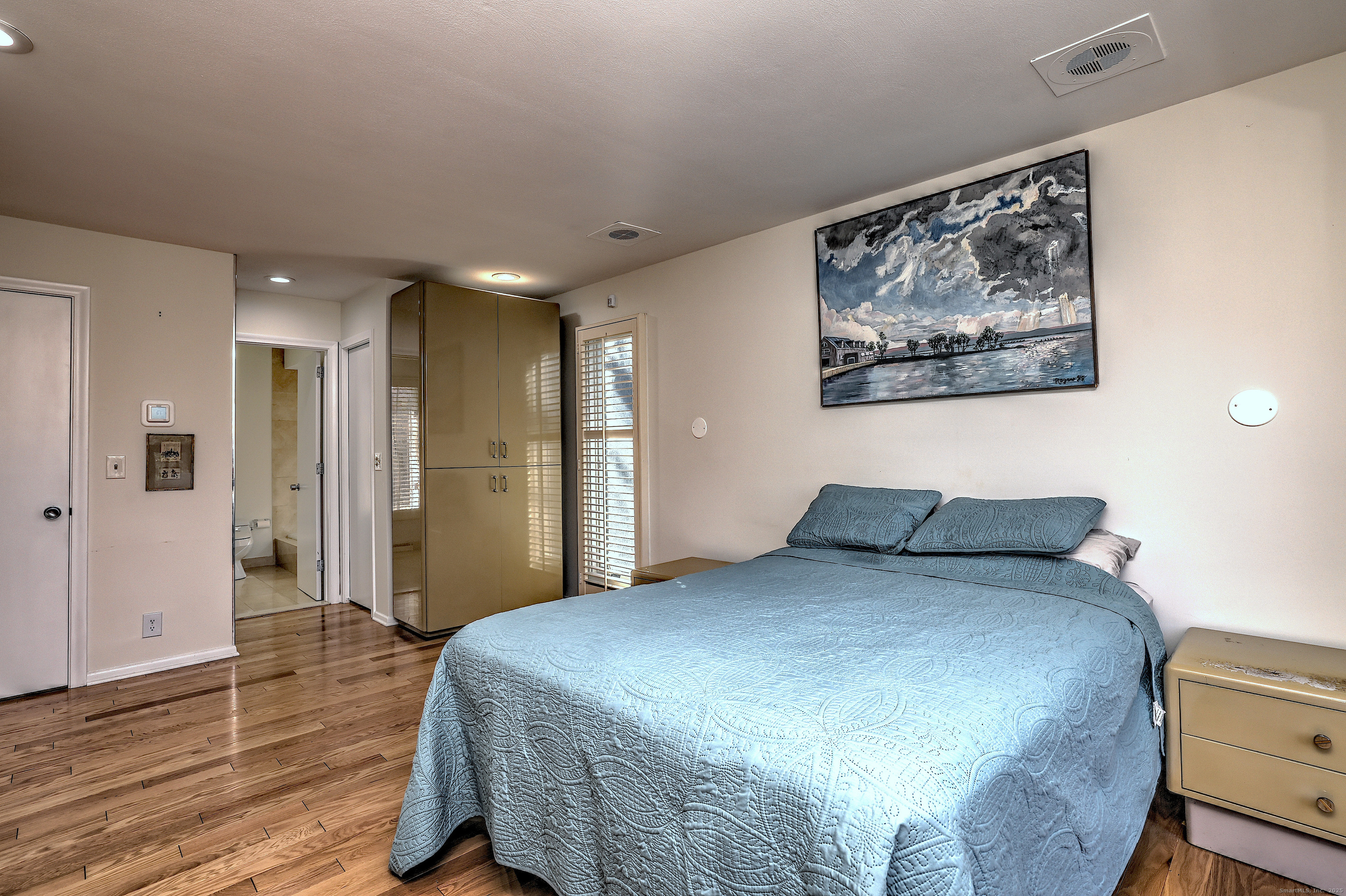 70 Woodfield Road Woodbridge, CT 06525 - Photo 22 of 37 a spacious bedroom with a bed and a painting on the wall