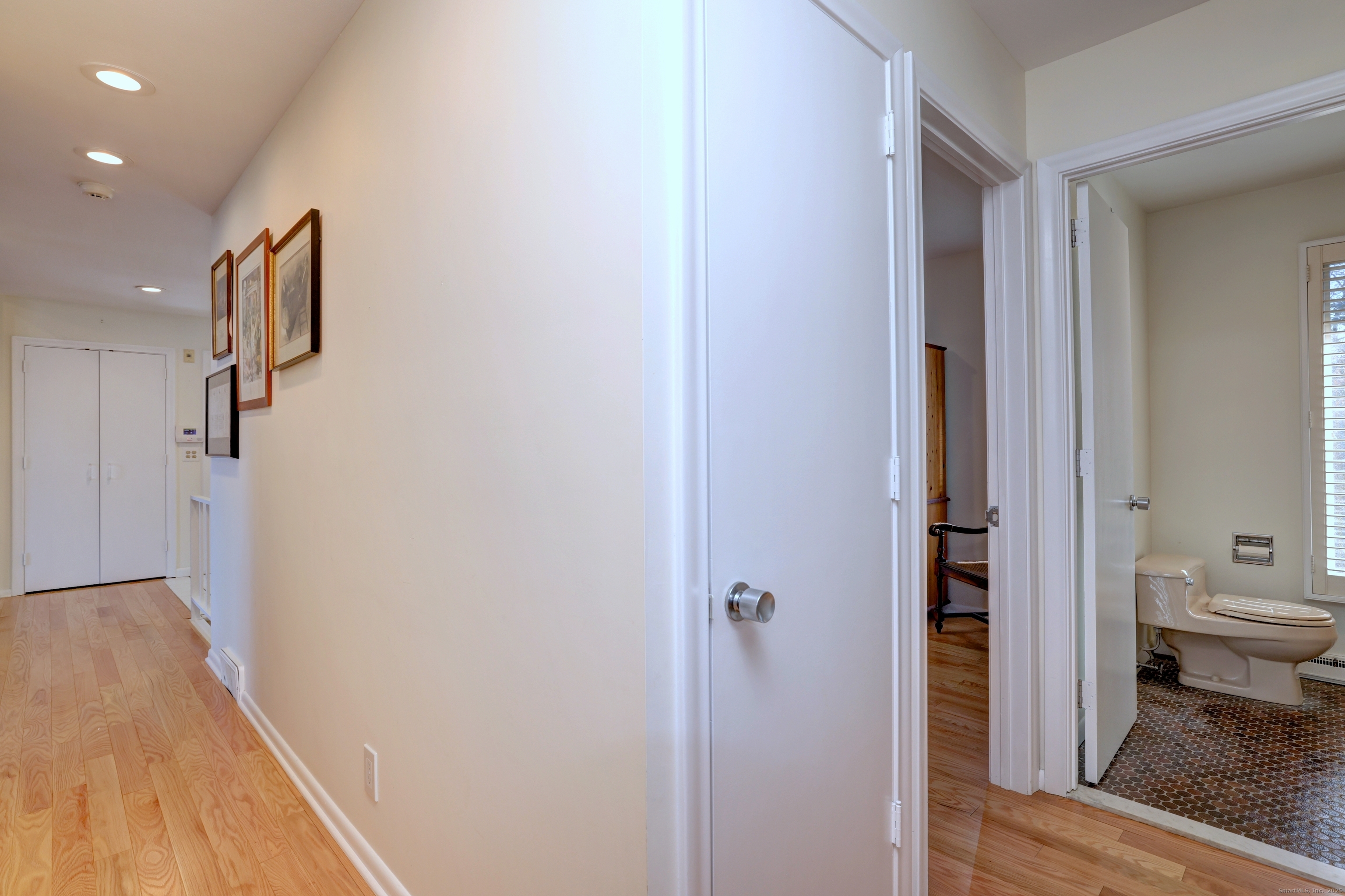 70 Woodfield Road Woodbridge, CT 06525 - Photo 24 of 37 a view of a hallway with wooden floor and a living room