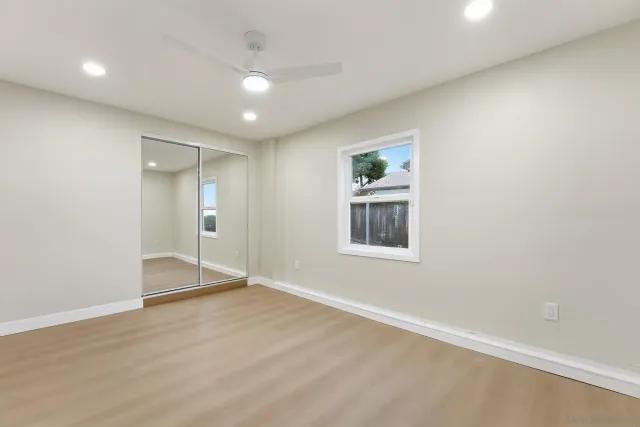a bathroom with a granite countertop sink a toilet and a mirror