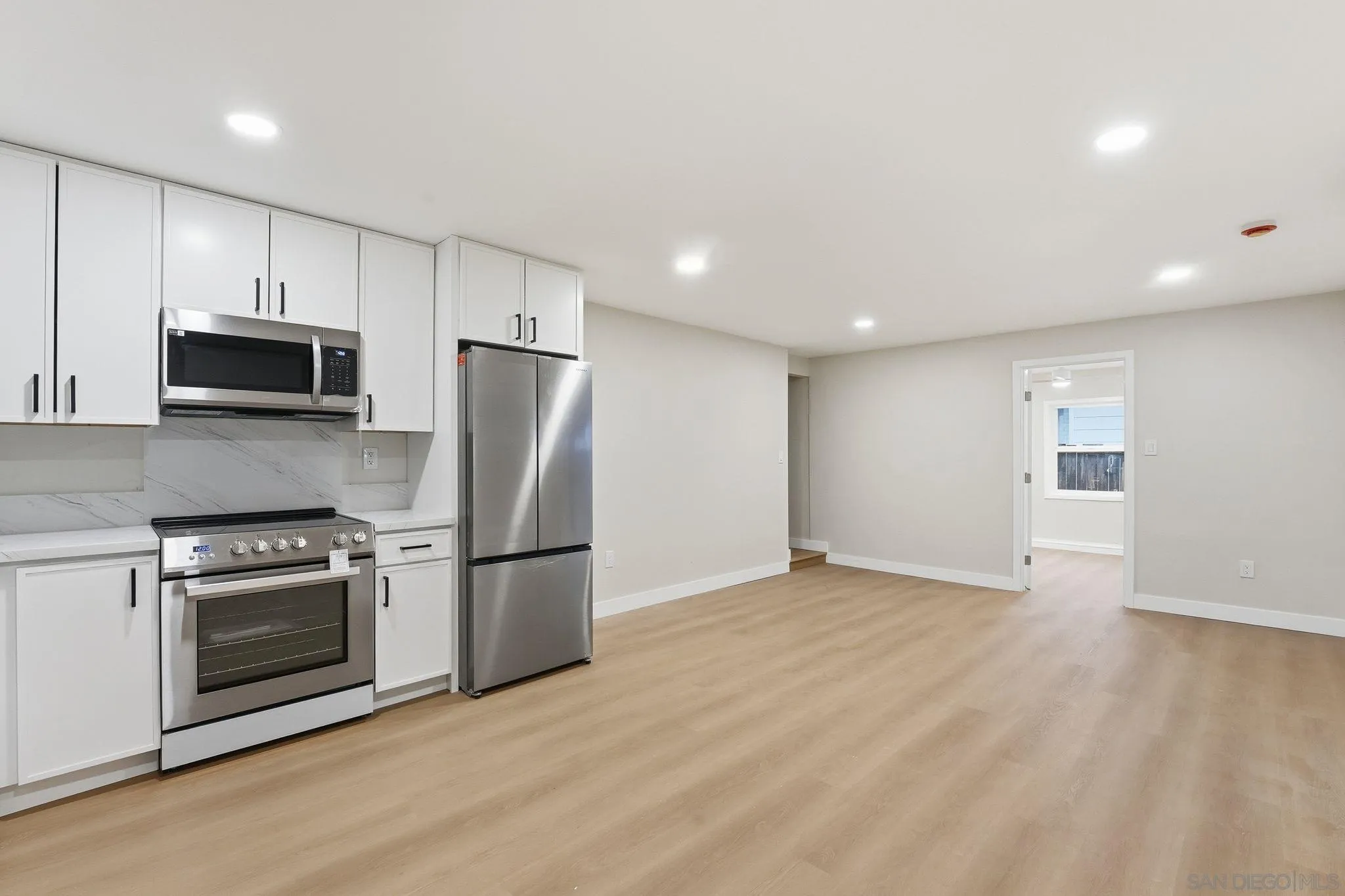 4800 Lee Avenue La Mesa, CA 91942 - Photo 38 of 60 a kitchen with stainless steel appliances granite countertop a refrigerator a stove a sink and a microwave