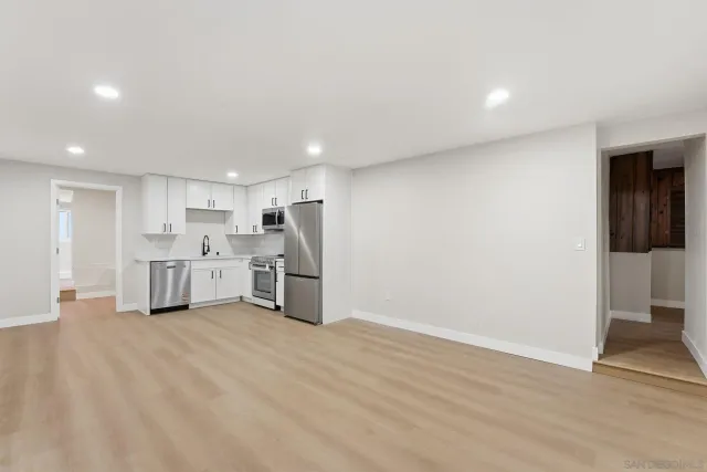 a view of a patio with a table and chairs under an umbrella