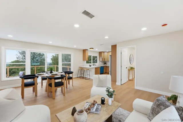 a kitchen with stainless steel appliances granite countertop a sink a stove a refrigerator and a refrigerator