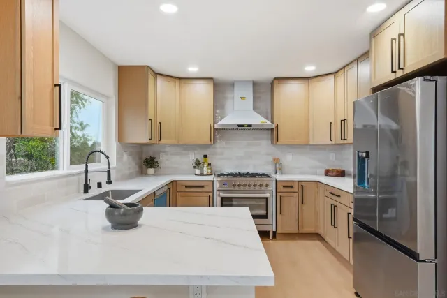 a stove top oven sitting inside of a kitchen