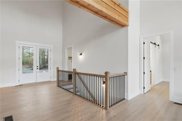 a view of an empty room with a fireplace and a window