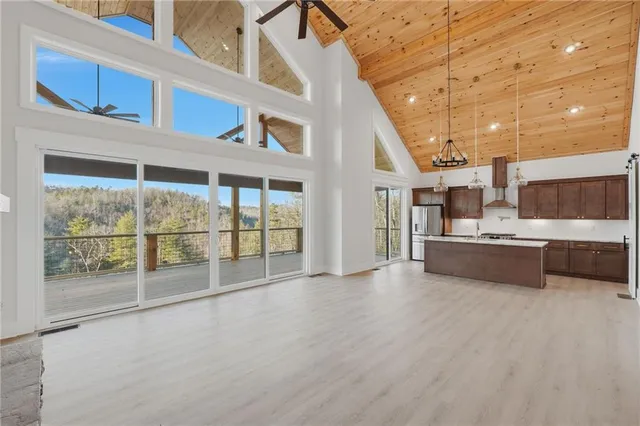 a kitchen with stainless steel appliances granite countertop a sink a stove and a refrigerator