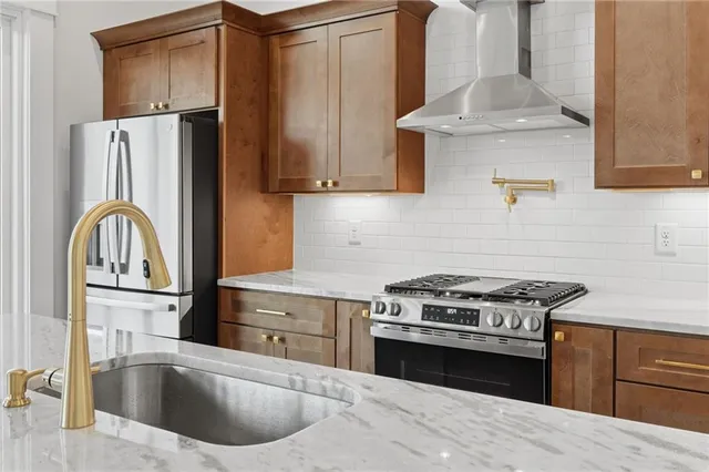 a kitchen with a granite countertop sink and a large window
