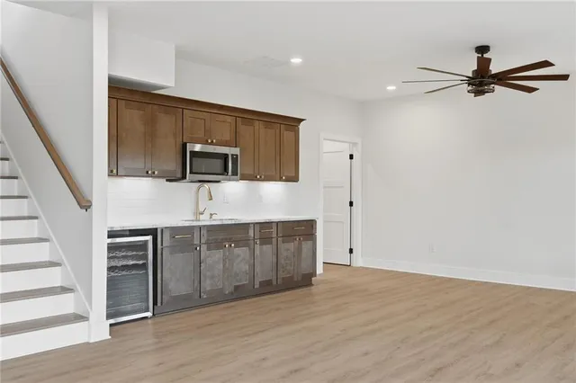 a view of empty room with wooden floor and ceiling fan
