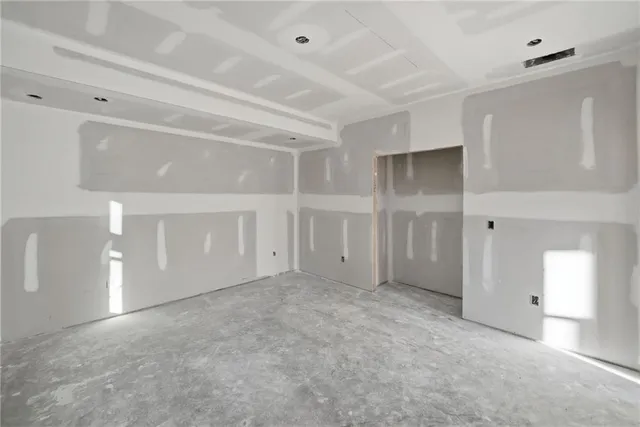 a view of a yard with plants and trees