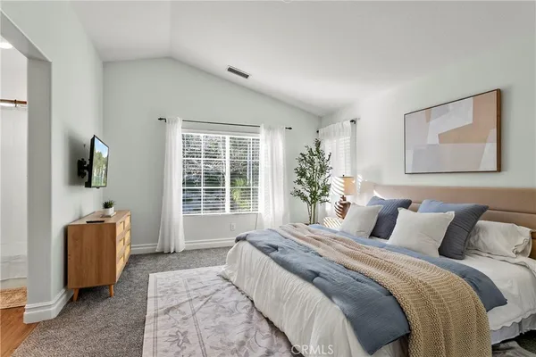 a bedroom with furniture and a large window