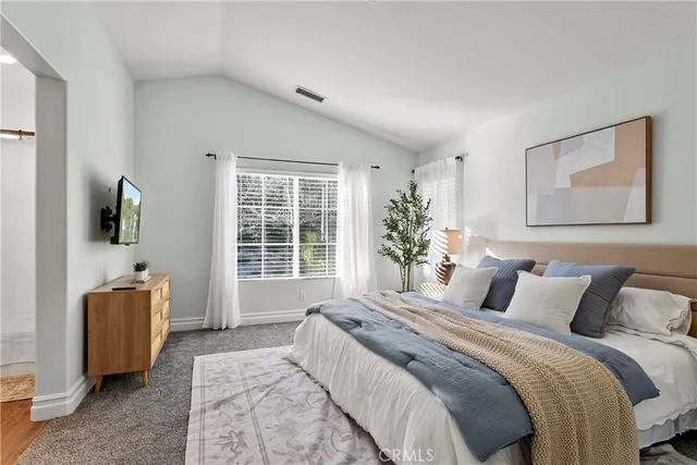 a bedroom with furniture and a large window