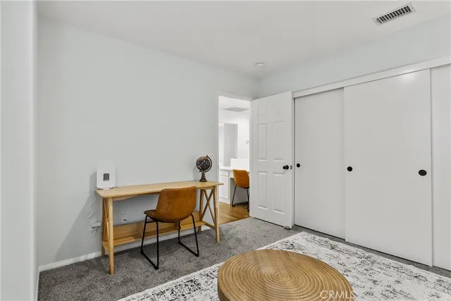 a bedroom with a bed and a table