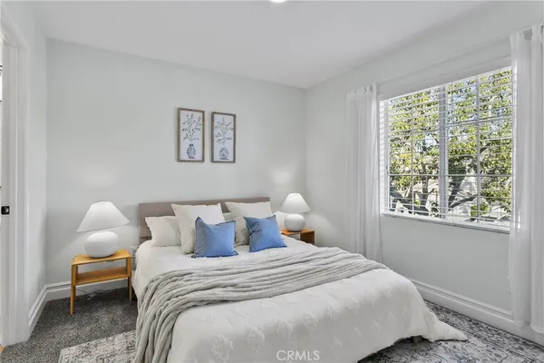 a bedroom with bed and window